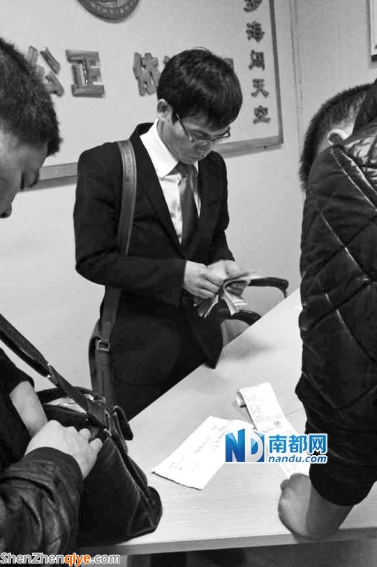 <p> 3月13日，與梁先生的撞車事故調解獲得賠償后，徐某在大浪交警中隊調解室數錢。</p><p> 南都記者 陳文才翻拍</p>